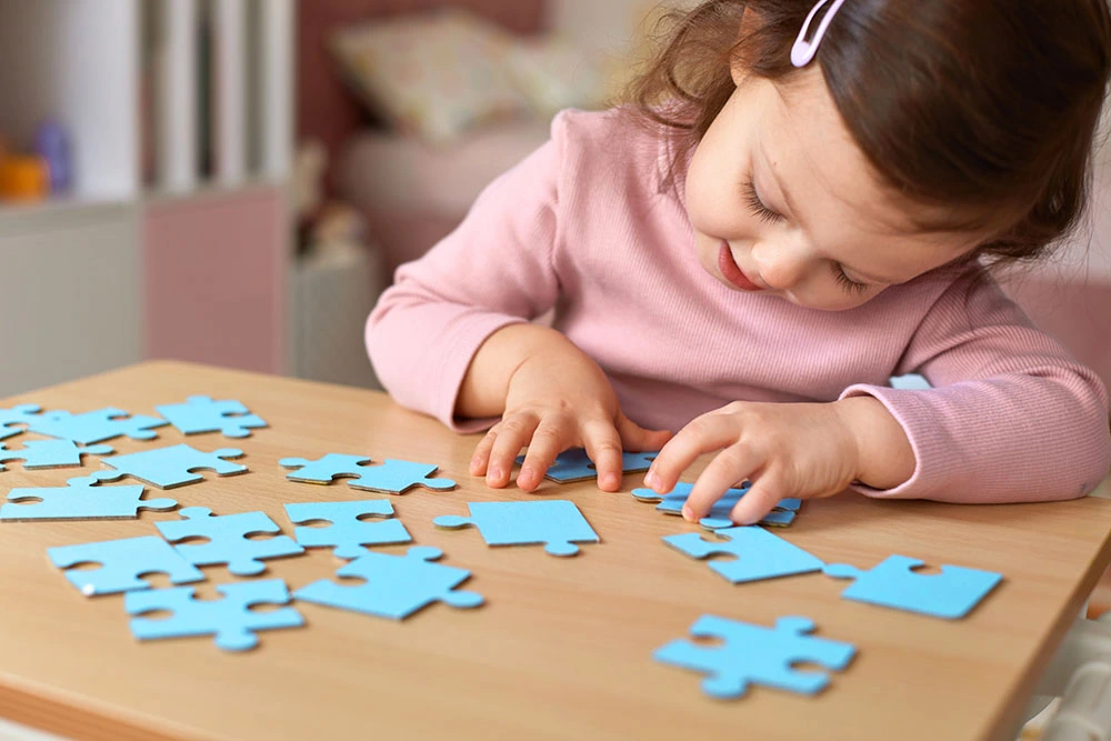 Young child completing a puzzle activity